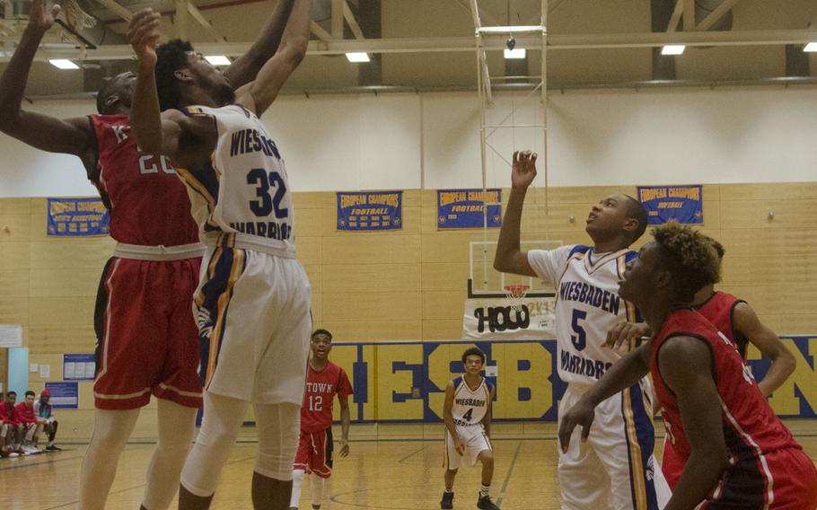 Wiesbaden's Markez Middlebrooks, second from left, and Kaiserslautern's Bryan Lunn contest a rebound during a holiday tournament matchup Monday, Dec. 18, 2017 in Wiesbaden, Germany. Kaiserslautern prevailed in the final game of the round-robin tournament, leaving both teams with 5-1 records over the six games.