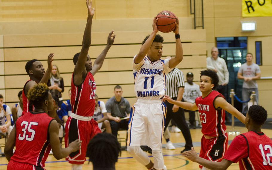 Wiesbaden's Tyrese Harris looks for a passing angle as he is surrounded by Kaiserslautern defenders during a holiday tournament matchup Monday, Dec. 18, 2017 in Wiesbaden, Germany. Wiesbaden, undefeated in the regular season, fell to the Raiders despite a furious second-half comeback attempt.