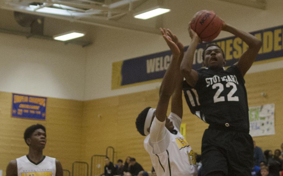 Ahmad Johnson of Stuttgart drives for a layup against a Baumholder defender during a holiday tournament matchup Monday, Dec. 18, 2017 in Wiesbaden, Germany. Stuttgart defeated the Bucs to go 3-2 overall in the round-robin tournament. 