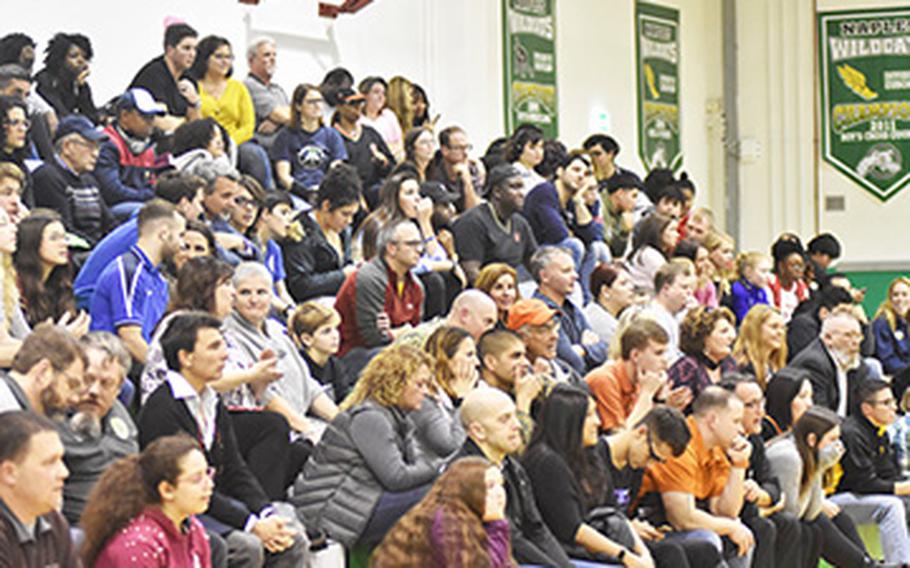 Audience members watch Cowboys and Wolfpack wrestlers compete Friday in the "Tussle for the Troops" in Naples, Italy. It was the first NCAA wrestling meet held outside the U.S.