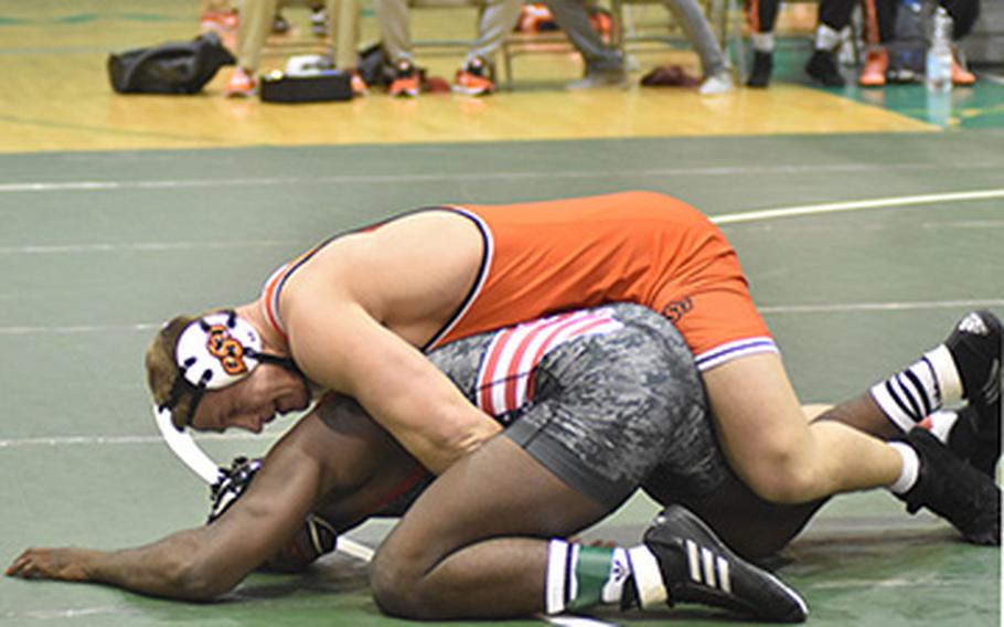 Cowboy heavyweight Derek White defeats the Wolfpack's Malik McDonald 8-0 on Friday in Naples, Italy. This was the first NCAA wrestling meet held in a foreign country.  