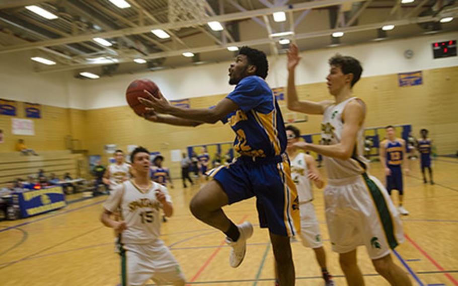 Wiesbaden's Markez Middlebrooks looks to score on a reverse layup during a DODEA-Europe Division I basketball matchup against SHAPE, Saturday, Jan. 13, 2018 in Wiesbaden, Germany. Wiesbaden won Saturday's game 66-31, scoring 31 points in a dominant third quarter.