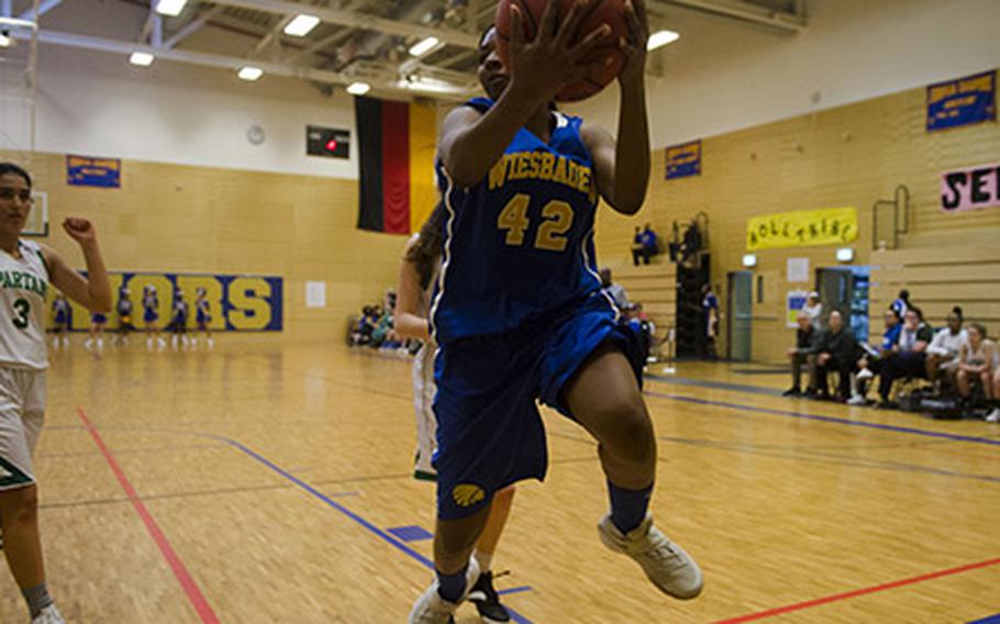 Wiesbaden's Corban Jackson saves the ball from going out of bounds during a DODEA-Europe Division I basketball matchup against SHAPE, Saturday, Jan. 13, 2018 in Wiesbaden, Germany. Jackson finished with eight points in Wiesbaden's narrow 38-37 win. 