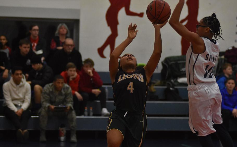 Aviano point guard AJ Hardy skies to reject the shot of AFNORTH's Aryanna Truss, but the Lions got the best of the Saints, 34-19, on Friday night at Aviano Air Base, Italy.
