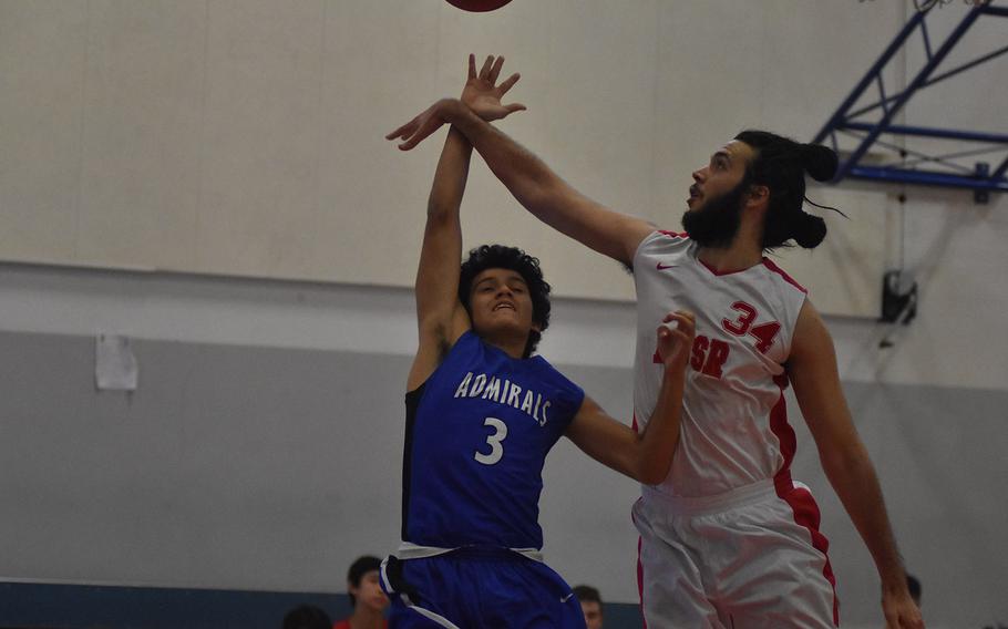 American Overseas School of Rome's Francesco Gristina rejects the shot of Rota's Ygnacio Reyes - one of seven blocks Gristina had in the Falcons 54-28 loss to the Admirals on Friday at Aviano Air Base, Italy.