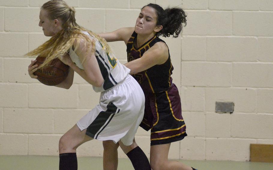 Baumholder's Sophia Rodriguez fights Alconbury's Marissa Kastler for the basketball during a high school game at RAF Alconbury, England, Friday, February 2, 2018. Rodriguez contributed nine points towards her team's first win of the season.