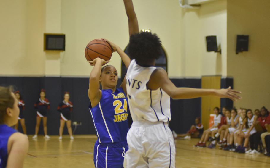 Aviano's Layla Thomas defends against Sigonella's Averi Chandler in the Jaguars' 40-33 victory over the Saints on Friday night.