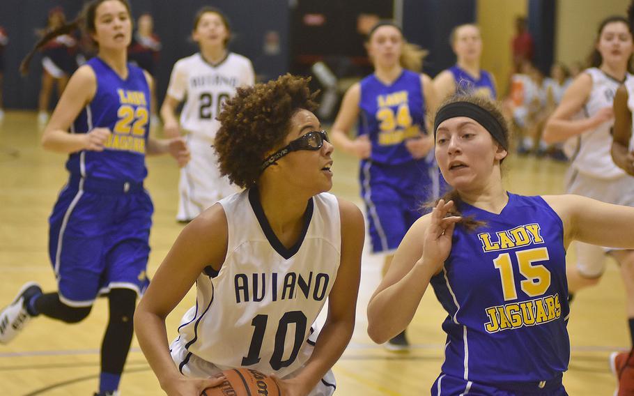Sigonella's Jessica Jacobs defends against Aviano's AJ Hardy in the Jaguars' 40-33 victory Friday night at Aviano Air Base, Italy.
