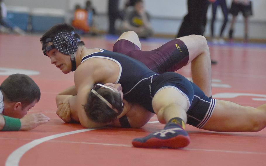 Munich's Blaise Ronnau pins Vilseck's Matthew Johnston to win the 160-pound weight class Saturday at the southern sectional.