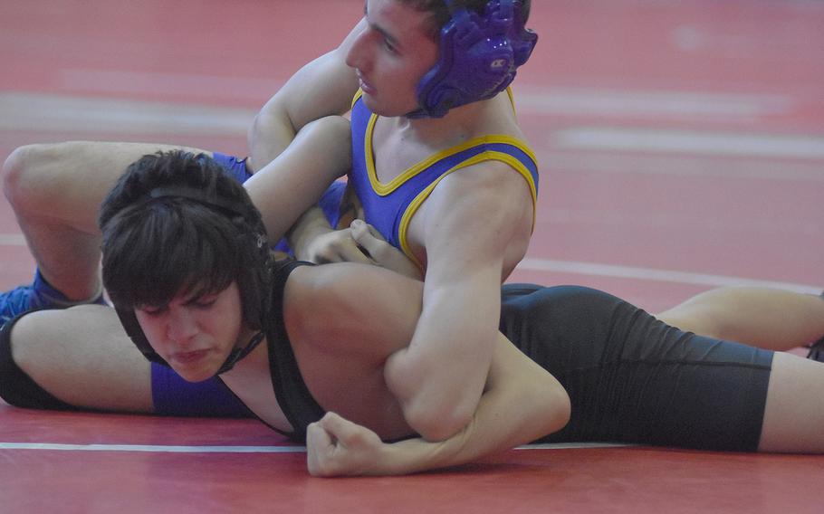 Sigonella's Munro Manning has the upper hand on Vicenza's Nicholas Verduga in a 113-pound match Saturday at the southern sectional. Manning won the match and took first in the sectional.
