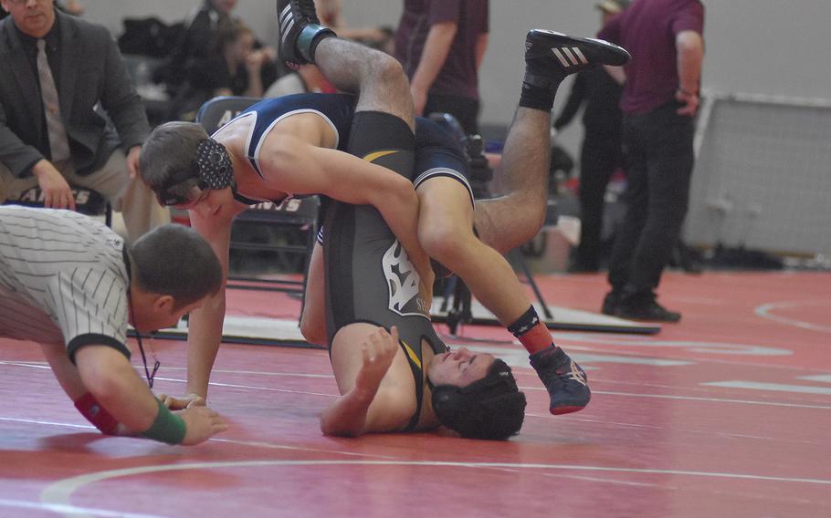 Munich's Drake Ronnau puts Vicenza's Sam Strong on his back at 170 pounds in an early-round match at the southern sectional Saturday at Aviano Air Base. Ronnau stayed unbeaten and took first in the class.