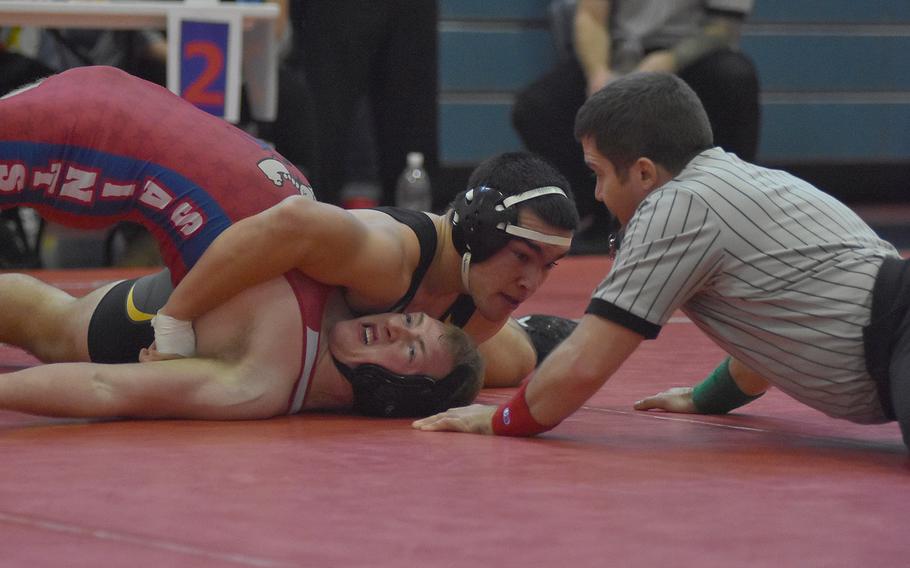 Vicenza's Ethan Johnston pins Aviano's Ayden Capps to take first at 182 pounds in the southern sectional on Saturday.