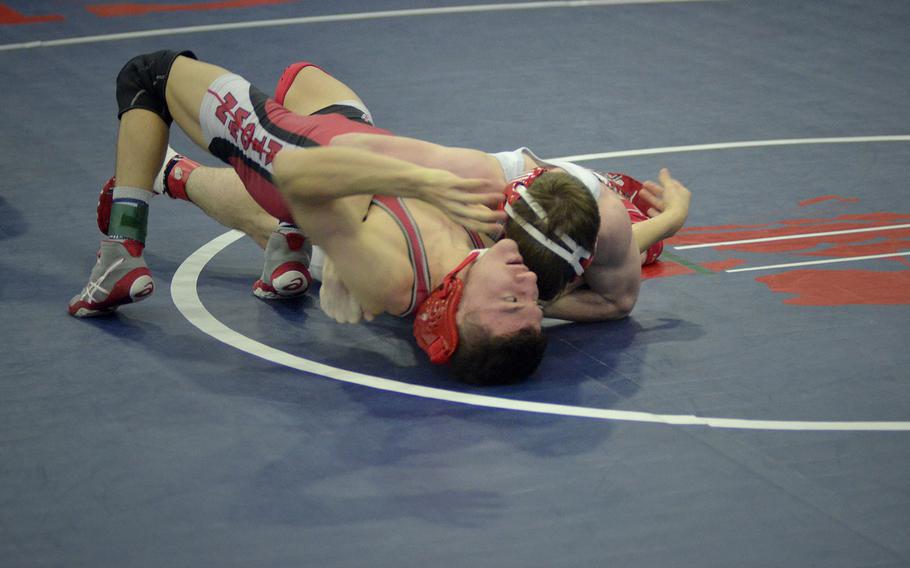 Kaiserslautern's Conner Mackie bridges to defend against a pin from Lakenheath's Kyle Boren during the 120-pound championship match at the wrestling northern sectional at RAF Lakenheath, England, Saturday, February 10, 2018. Mackie's calm defense techniques led to a victory over Boren with a pin later in the match.