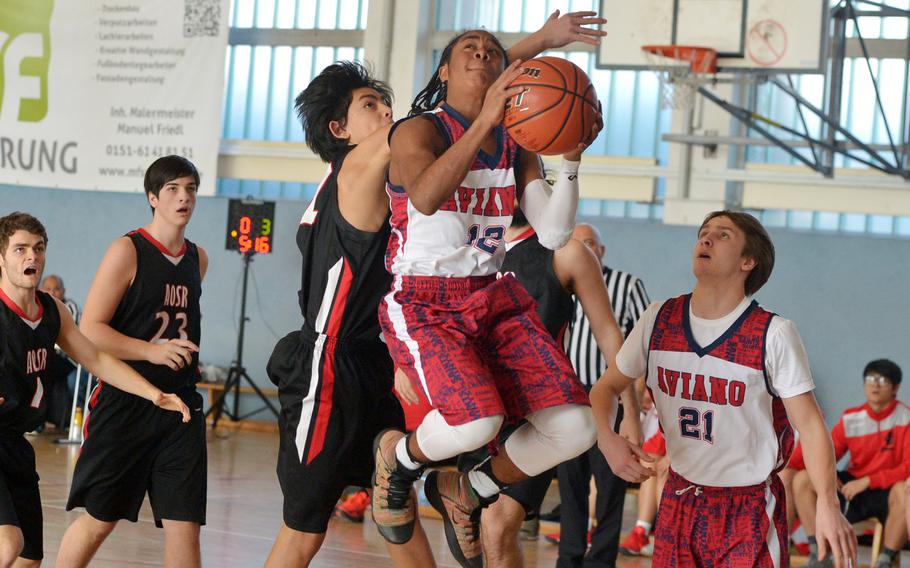 Aviano's Traevian Ware loops for a shot after getting past AOSR's Cyrus Watkins in a Division II game at the DODEA-Europe basketball championships in Wiesbaden, Germany, Wednesday, Feb. 21, 2018. Aviano beat AOSR 39-23.