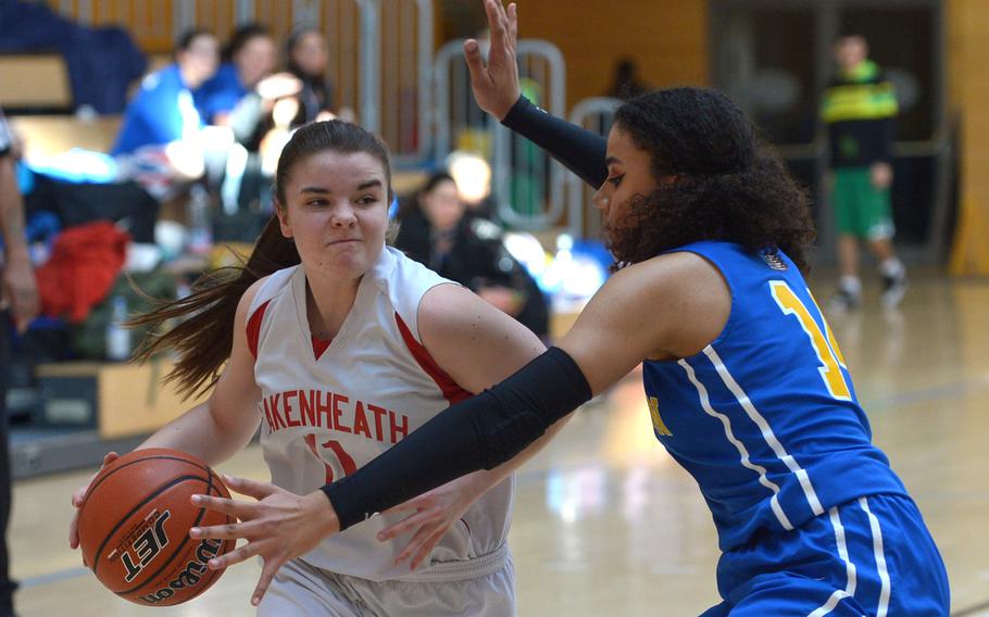 Lakenheath's Allison Stangl drives against Wiesbaden's Amani Robinson in a Division I game at the DODEA-Europe basketball championships in Wiesbaden, Germany, Wednesday, Feb. 21, 2018. Lakenheath beat Wiesbaden 26-25.