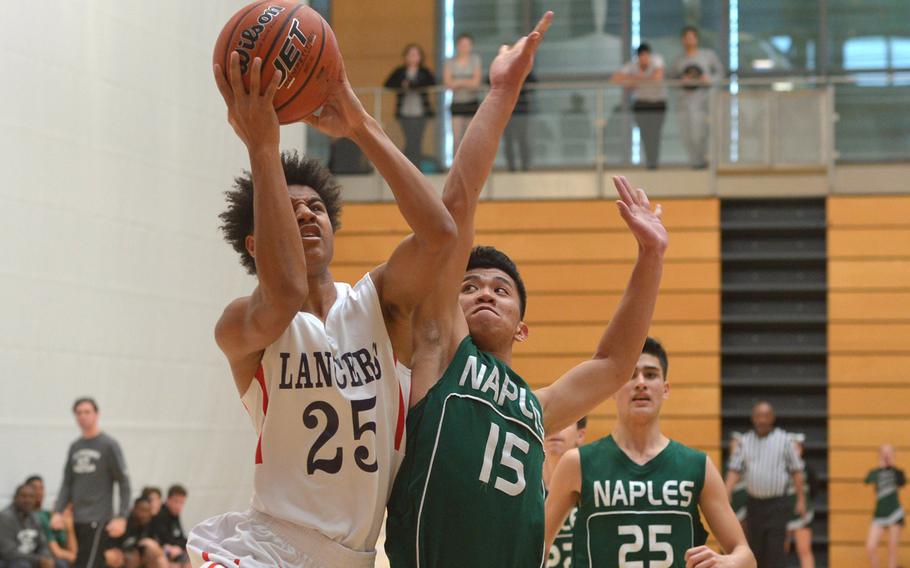Lakenheath's Jordan Harris aims for the basket as Naples' Mark Calumpang tries to defend. Naples beat Lakenheath 59-46 in a Division I game at the DODEA-Europe basketball finals in Wiesbaden, Germany, Thursday, Feb. 22, 2018. 