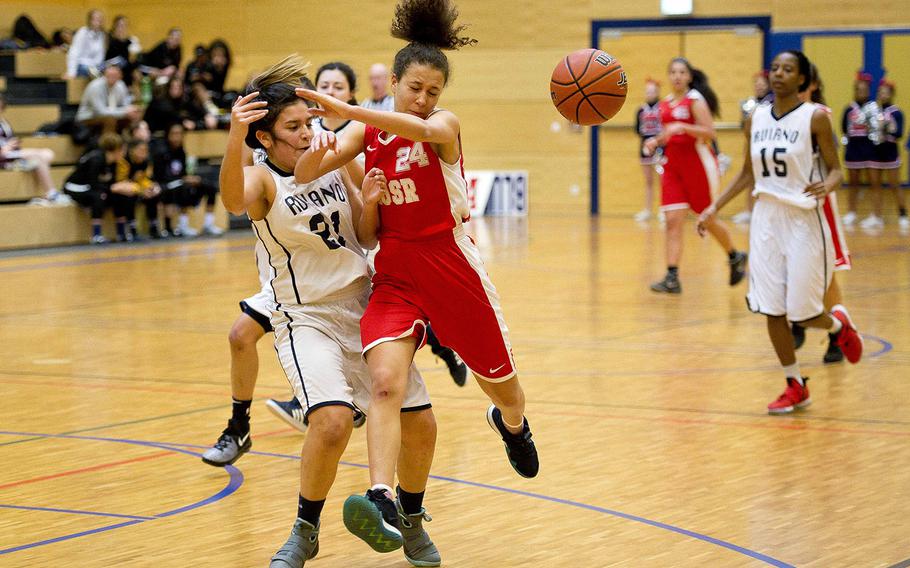 Aviano's Jasmine Vasquez, left, and American Overseas School of Rome's Rebecca Davis collide as they race for the ball during the DODEA-Europe basketball championships in Wiesbaden, Germany, on Thursday, Feb. 22, 2018. AOSR won the game 40-24.