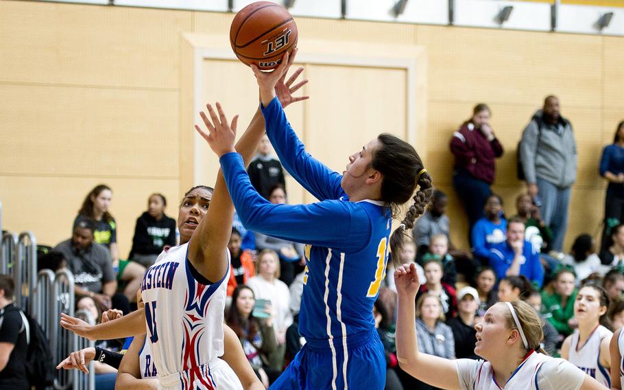 Wiesbaden's Alaina Houk, right, goes up for a shot over Ramstein's Reinha Williams during the DODEA-Europe basketball championships in Wiesbaden, Germany, on Thursday, Feb. 22, 2018. Ramstein won the game 26-12.