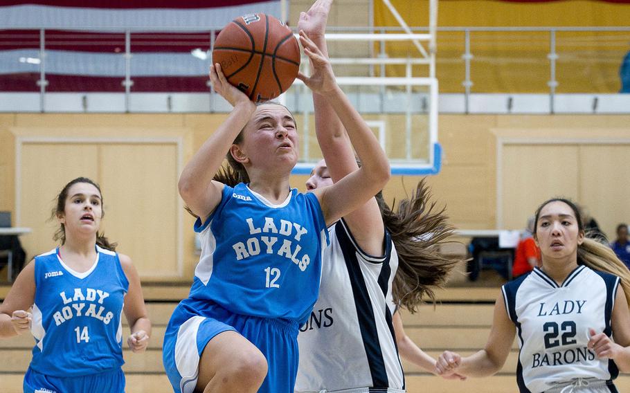 Marymount's Charlotte Vitalo, left, goes for a layup past Spangdhalem's Emerson Retka during the DODEA-Europe Division II basketball semifinals in Wiesbaden, Germany, on Friday, Feb. 23, 2018.