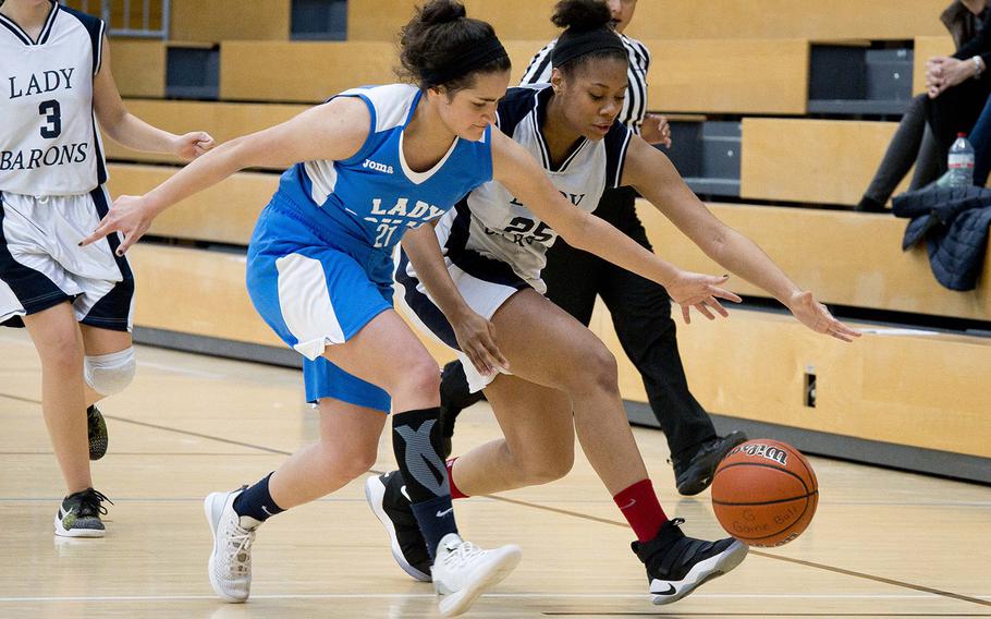 Spangdhalem's Amadi Bradshaw, right, and Marymount's Marian Hassan race for the ball during the DODEA-Europe Division II basketball semifinals in Wiesbaden, Germany, on Friday, Feb. 23, 2018.