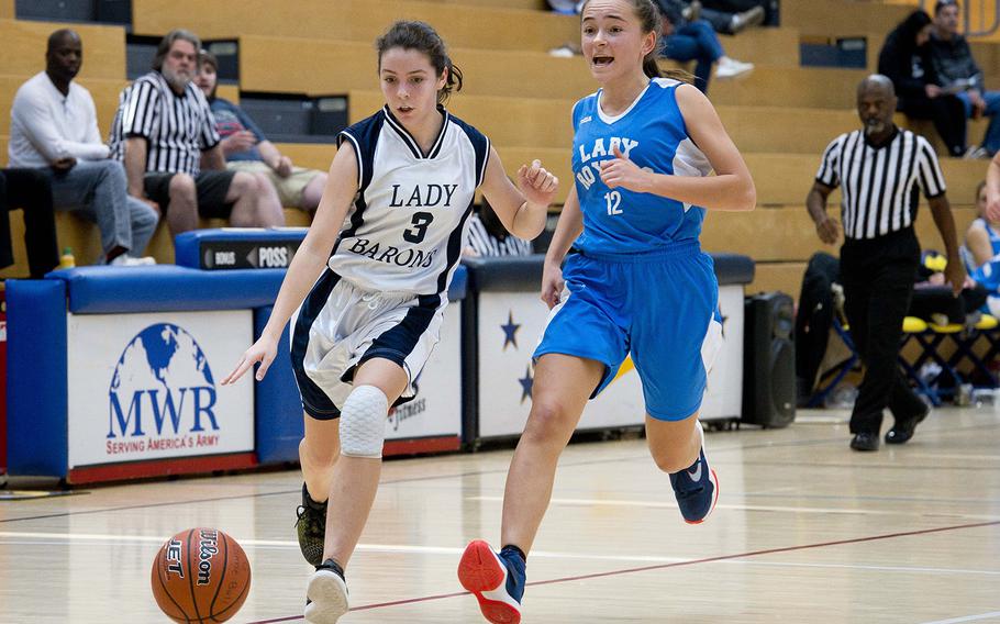 Spangdhalem's Emma Passig, left, dribbles past Marymount's Charlotte Vitalo during the DODEA-Europe basketball Division II semifinals in Wiesbaden, Germany, on Friday, Feb. 23, 2018.