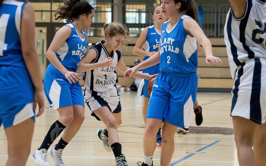 Spangdhalem's Ava Bohn tries to split Marymount's Marian Hassan, left, and Andrea Riviere during the DODEA-Europe basketball semifinals in Wiesbaden, Germany, on Friday, Feb. 23, 2018. Spangdhalem won the Division II game 23-18.
