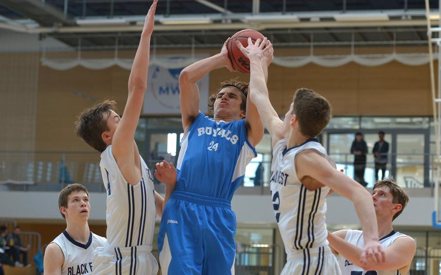 Marymount's Michele Buscarini shoots against Black Forest Academy's Gabriel Kruse and Jacob Fortune in a Division II semifinal at the DODEA-Europe basketball finals in Wiesbaden, Germany, Friday, Feb. 23, 2018. BFA won 69-38 to advance to Saturday's final against Rota.
