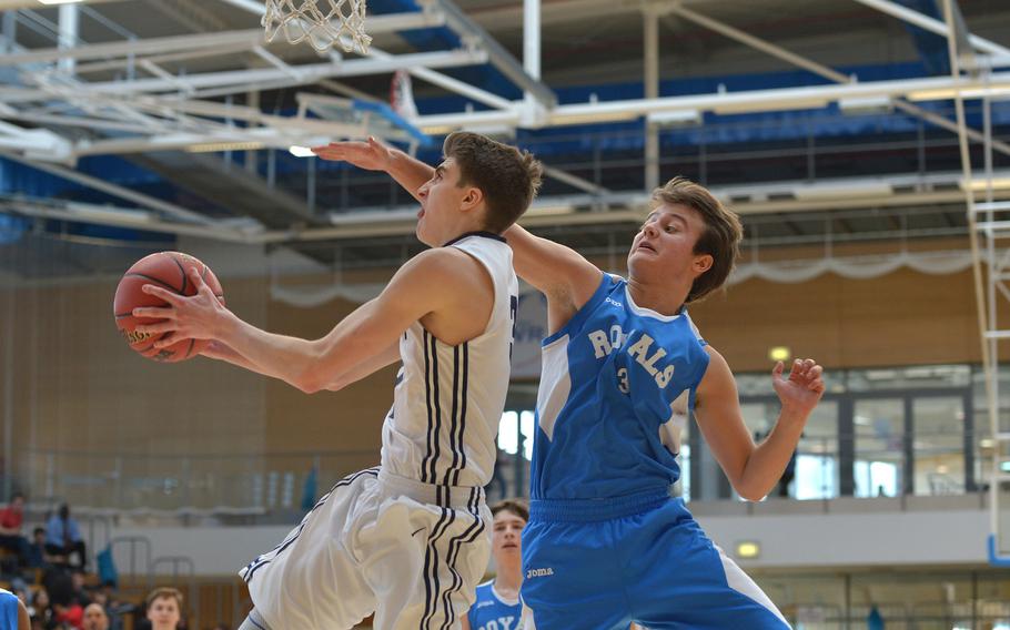 Black Forest Academy's Jacob Fortune goes in for a reverse layup against Marymount's Mario Freilino in a Division II semifinal at the DODEA-Europe basketball finals in Wiesbaden, Germany, Friday, Feb. 23, 2018. BFA won 69-38 to advance to Saturday's final against Rota.
