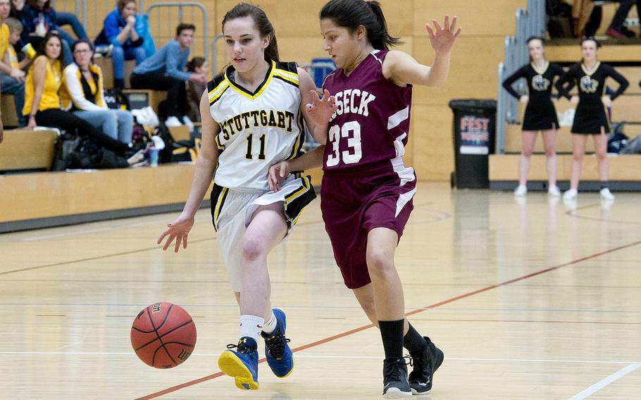 Stuttgart's Chloey Bolen, left, tries to dribble past Vilseck's Adlynn Huezo during the DODEA-Europe Division I basketball semifinals in Wiesbaden, Germany, on Friday, Feb. 23, 2018.