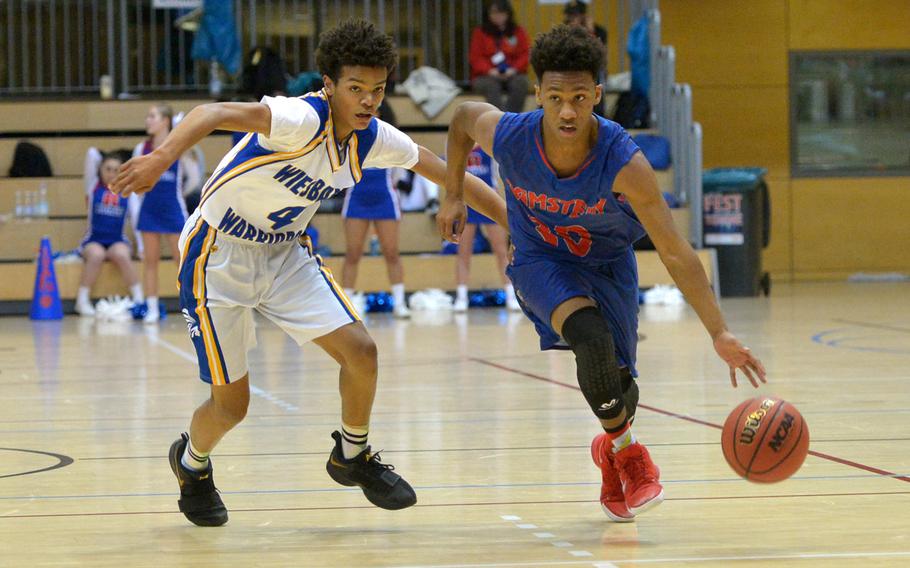 Ramstein's Jerod Little takes the ball up the court against Wiesbaden's Jaylen McFadden in a Division I semifinal at the DODEA-Europe basketball championships in Wiesbaden, Germany, Friday, Feb. 23, 2018. Ramstein won 44-41 and will play Kaiserslautern in Saturday's final.