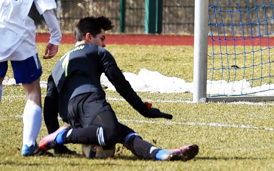 Ansbach goalie Nick Benson dives onto the ball during a game at Hohenfels, Germany, Saturday, March 24, 2018. 