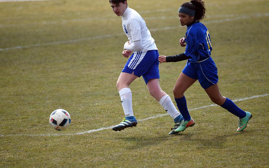 Ansbach's Desha Boswell, right, and Hohenfels' Shane Colbert, race to the ball during a match at Hohenfels, Germany, Saturday, March 24, 2018. 