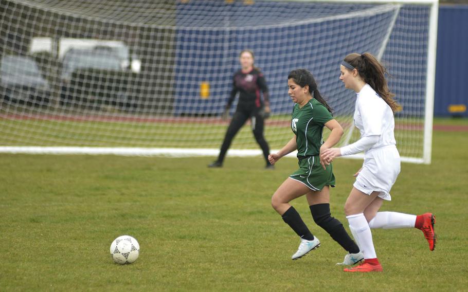 Alconbury's Ruby Mora defends against Brussels' Olivia Friedhoff during a soccer game at RAF Alconbury, England, Saturday, March 24, 2018. The Dragons won 3-2 against the Brigands.
