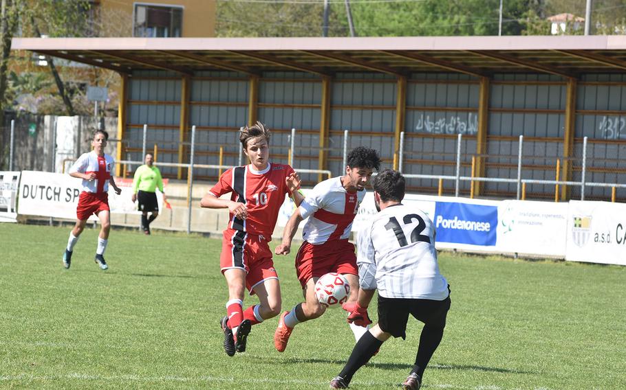 Aviano goalkeeper Giacomo Fabbro reaches the ball ahead of teammate Pablo Cervantes and AOSR's Alessandro Ianni in the Falcons' 2-1 victory on Saturday, April 21, 2018.
