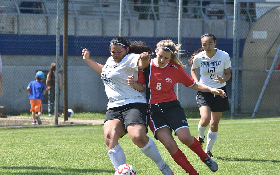 Aviano's Jocelyn Sauceda and American Overseas School of Rome's Virginia Amici collide while trying to get the ball in the Falcons' 3-1 victory on Saturday, April 21, 2018.