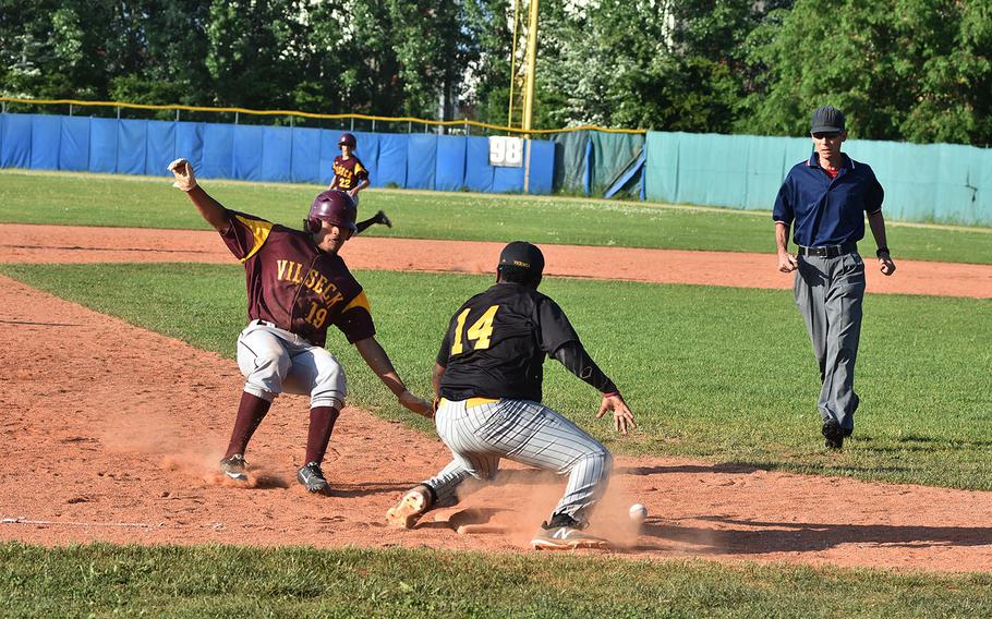 Vilseck's Chris Graveley slides into third as the ball drops to the ground in front of Vicenza third baseman Jesse Swinehart on Friday, April 27, 2018, in Vicenza, Italy.