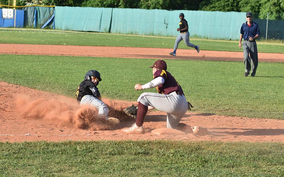Vicenza's Jesse Samsel creates a nice cloud of dust while sliding into third base, but Vilseck's Jordan Leighty tags him out in the Falcons' 6-3 victory on Friday, April 27, 2018.