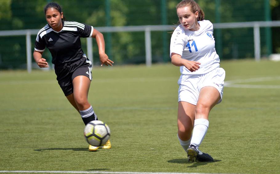 Wiesbaden's Audrey Merhar takes a shot as Vicenza's Angelina Yepez hurries back to help defend. Wiesbaden won the Division I game at the the DODEA-Europe soccer finals in Reichenbach, Germany, 3-1.