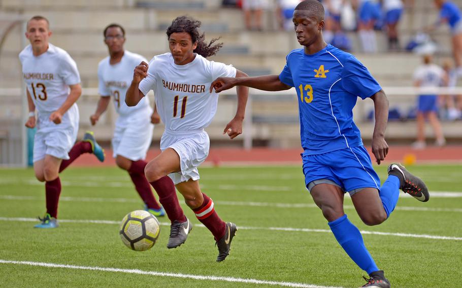 Ansbach's Kevin Kamara pushes the ball upfield against Baumholder's Demauriay Medina in Division III action at the DODEA-Europe soccer finals in Kaiserslautern, Germany, Monday, May 21, 2018. The Cougars beat the Bucs 7-0.
