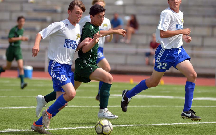 Sigonella's Connor Smithgall  and Alconbury's Kendall Cordoba fight for the ball in Division III action at the DODEA-Europe soccer finals in Kaiserslautern, Germany, Monday, May 21, 2018. Alconbury won 2-1.





