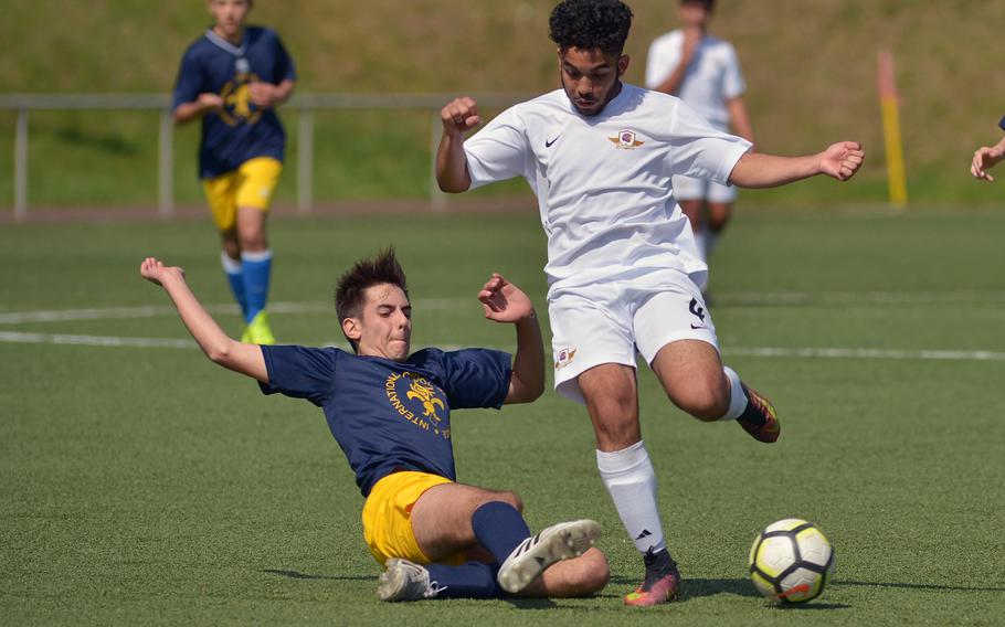 Florence's Mario Bacci, left, tackles Bahrain's Carlos Barrero in Division II action at the DODEA-Europe soccer finals in Landstuhl, Germany, Monday, May 21, 2018. Florence won 1-0.





