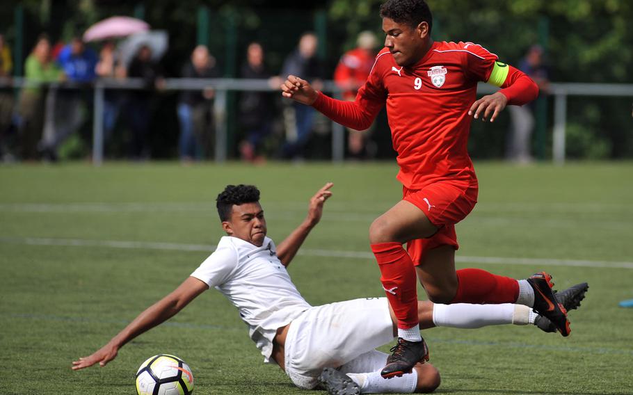 Kaiserslautern's Pablo Zorrilla gets past Ramstein's Noah Yancy at the DODEA-Europe soccer championships in Reichenbach, Germany, Tuesday, May 22, 2018. The teams played to a 1-1 tie and both advanced to Wednesday's semifinals.