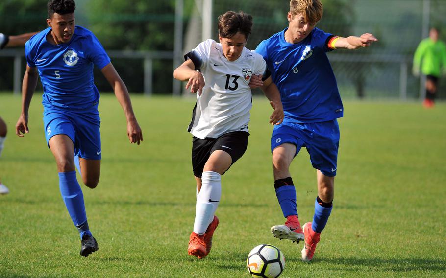 Stuttgart's Tanner Balisky battles for the ball with Ramstein's Gregory McMillan in a Division I semifinal at the DODEA-Europe soccer championships in Reichenbach, Germany, Wednesday, May 23, 2018. Stuttgart beat Ramstein 1-0 to advance to Thursday's final. At left is Ramstein's Noah Yancy.