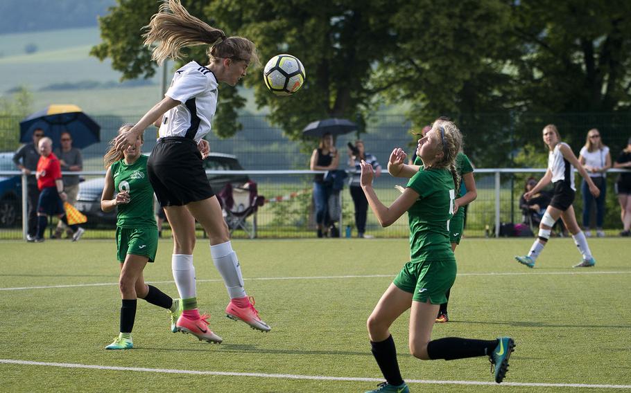 Stuttgart's Caylee Creer, left, heads the ball toward Naples' Roxanne Sasse during the DODEA-Europe soccer championships in Reichenbach, Germany, on Wednesday, May 23, 2018. Stuttgart won the Division I semifinal match 3-1.
