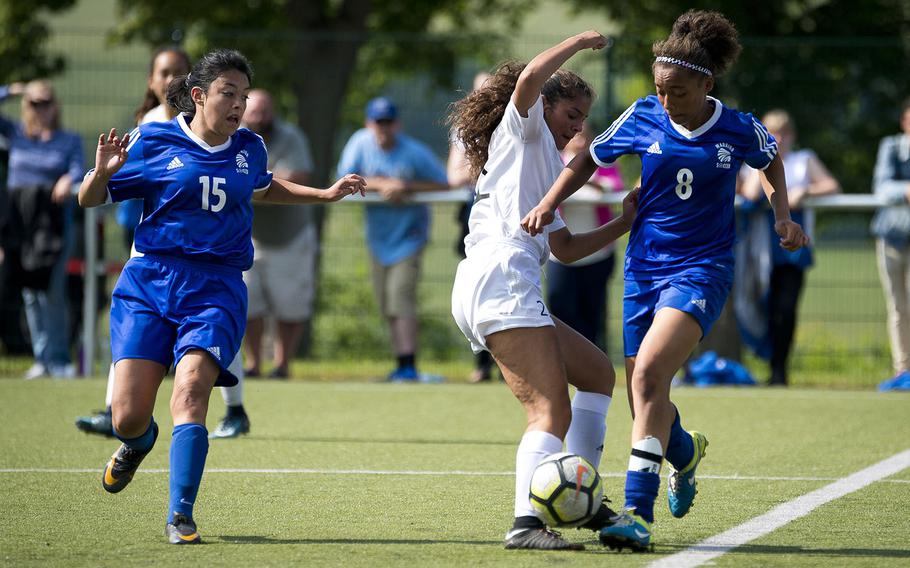 Wiesbaden's Jade Anderson, right, steals the ball from Ramstein's Jaelynn Galindo as fellow Warrior Brianna Greenfield runs to assist during the DODEA-Europe soccer championships in Reichenbach, Germany, on Wednesday, May 23, 2018.
