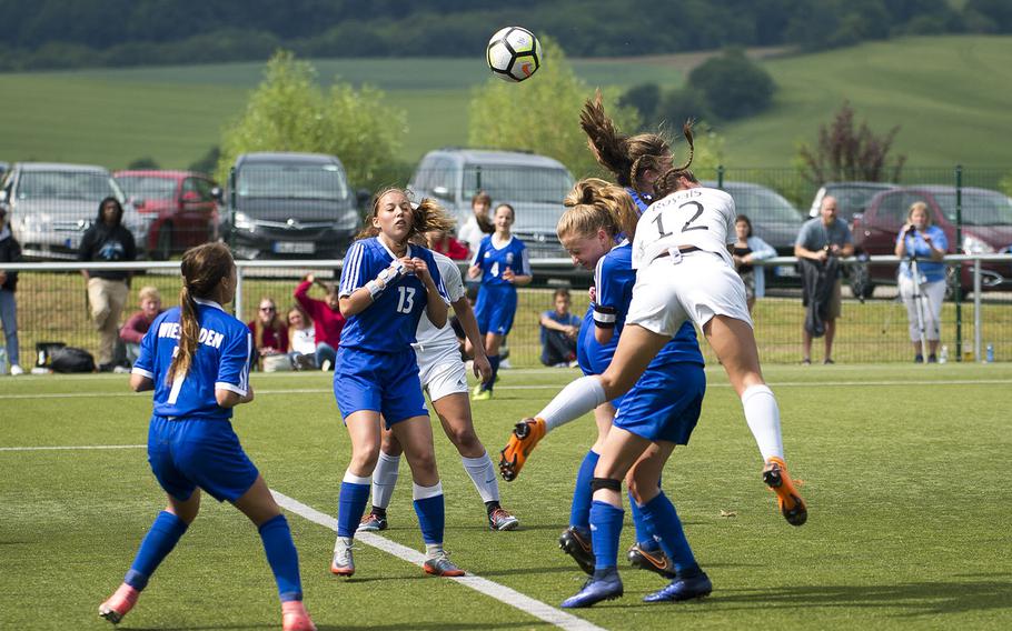 Ramstein's Aurora Davis, right, heads a corner kick during the DODEA-Europe soccer championships in Reichenbach, Germany, on Wednesday, May 23, 2018.
