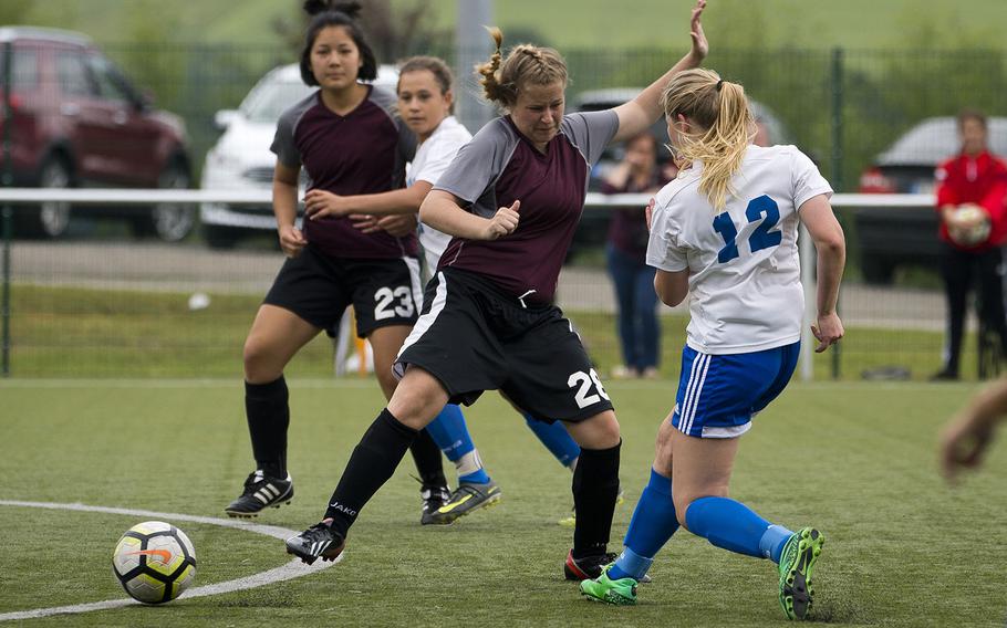 Rota's Hailey Gruetter, right, gets a shot off past AFNORTH's Jeanna Barrick during the DODEA-Europe soccer championships in Reichenbach, Germany, on Wednesday, May 23, 2018. Rota won the Division II semifinal match 3-1.