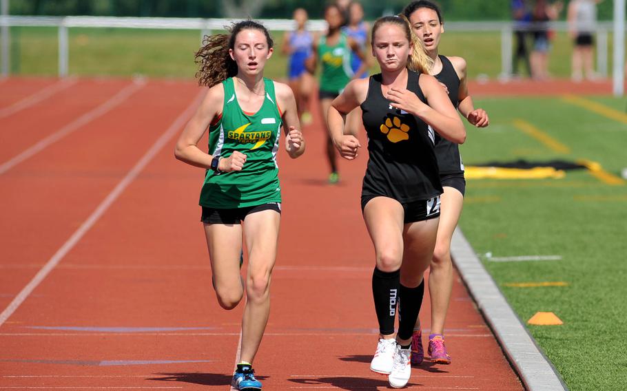 Stuttgart's McKinley Fielding, center, leads SHAPE's Holly Moser and teammate Tatiana Smith around the track midway through the girls 3,200-meter race at the DODEA-Europe track and field championships in Kaiserslautern, Germany, Friday, May 25, 2018. Fielding won the race in 11 minutes 48.80 seconds.





