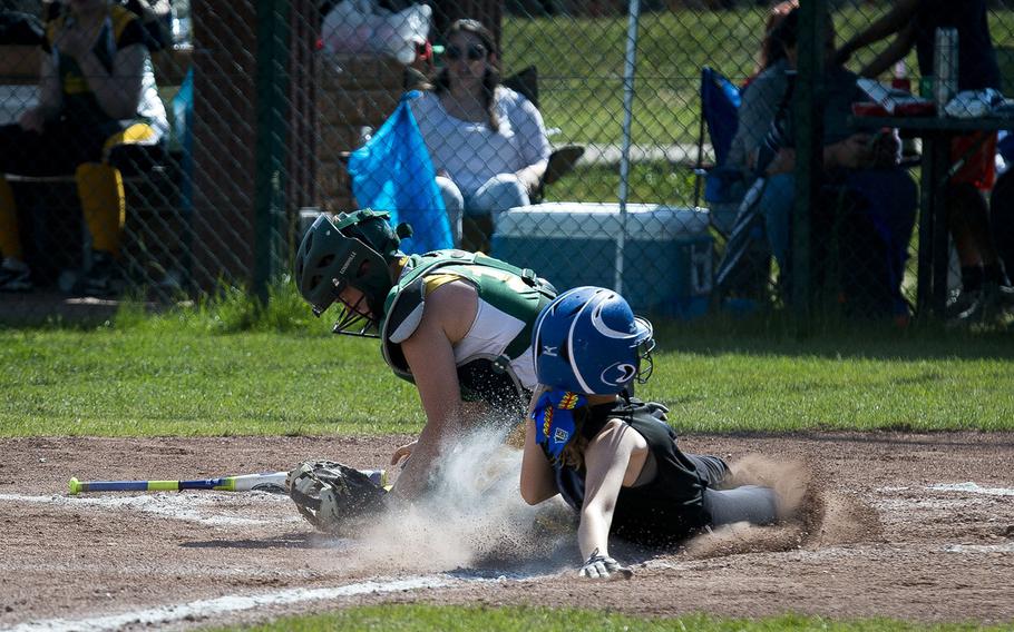 Hohenfels' Aubrey Bruhn, right, slides in safe at home ahead of a tag by Alconbury's Vivian Newcomer during the DODEA-Europe softball tournament at Ramstein Air Base, Germany, on Friday, May 25, 2018. Hohenfels won the Division II/III game against Alconbury 16-3.