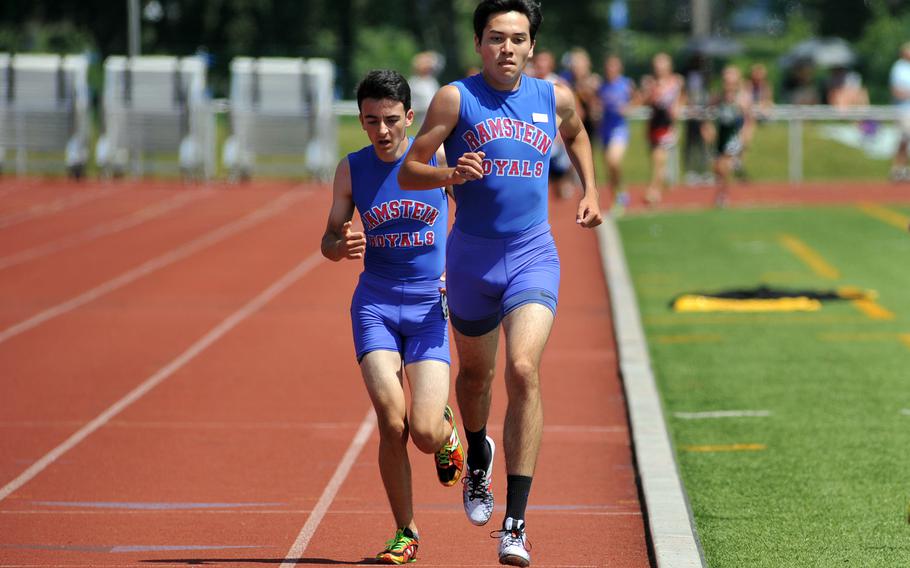 Jose Serrano leads teammate Dashiell Rogers in the boys 3,200-meter run at the DODEA-Europe track and field championships. In a race with numerous lead changes between the two, Serrano came out in front, winning in 9 minutes, 51.43 seconds, a new DODEA-Europe record.